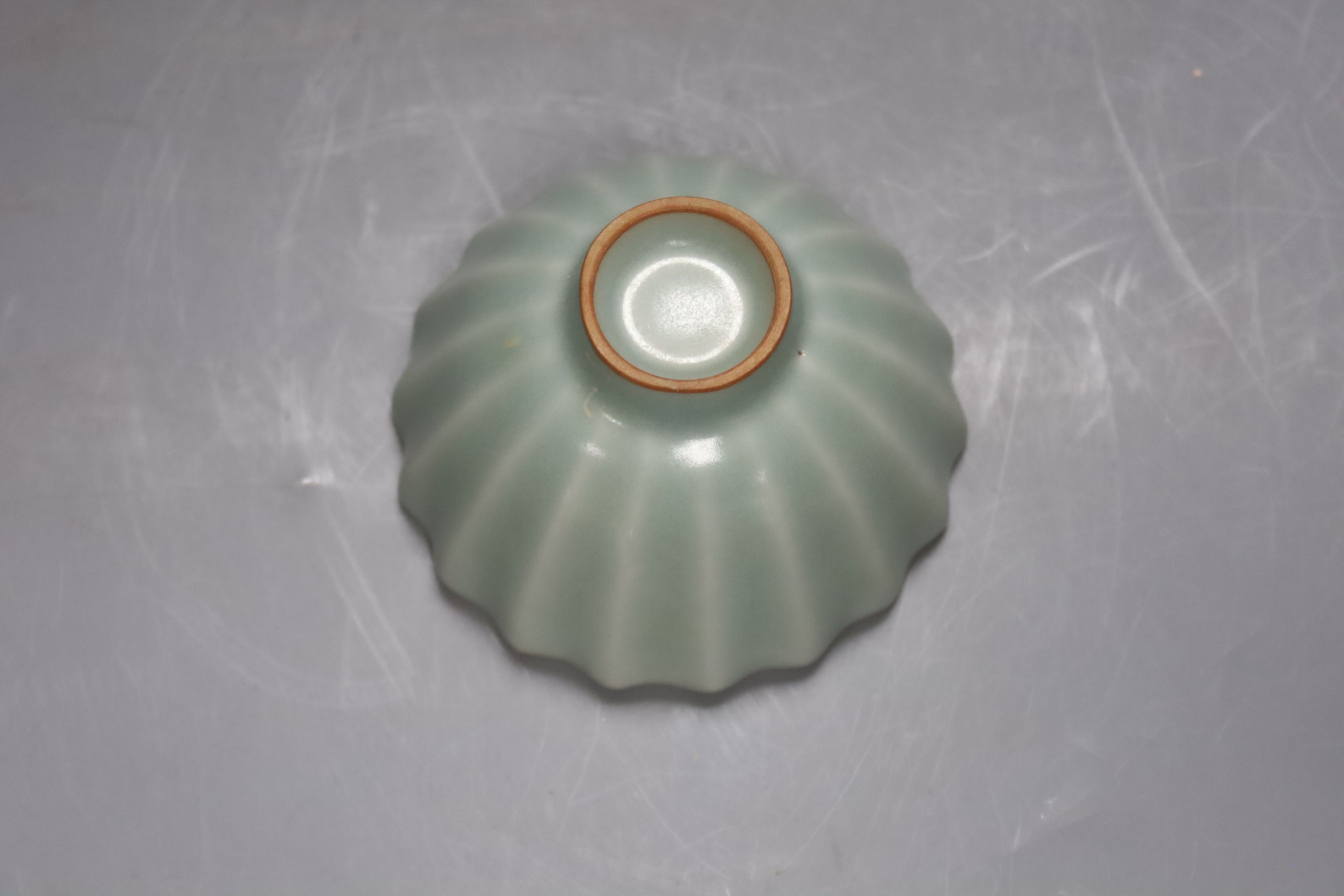 A Chinese celadon fluted cup, 9cm